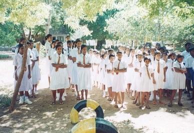 Students gathering in the playground to greet Bhante.